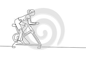 One continuous line drawing of young sporty woman working out static stationary bicycle in fitness gym club center. Healthy
