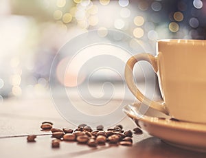 One cup of coffee and coffee beans on a wooden board