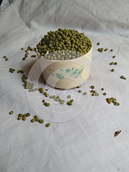 One cup green mung Bean on white cloth background isolated photo