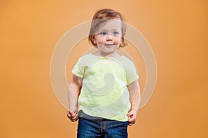 One cute baby girl on orange background