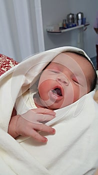 One day old infant with open mouth