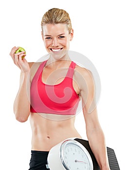 One day soon, youll be someone elses fitspiration. Studio shot of a woman holding an apple and a scale.