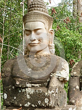 A Guardian God at the North Gate to Angkor Thom photo