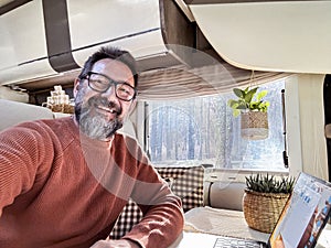 One digital nomad working inside a camper van travel lifestyle vehicle vanlife using laptop computer and roaming internet