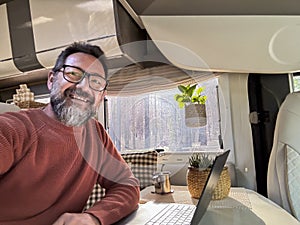 One digital nomad working inside a camper van travel lifestyle vehicle vanlife using laptop computer and roaming internet