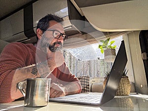 One digital nomad working inside a camper van travel lifestyle vehicle vanlife using laptop computer and roaming internet