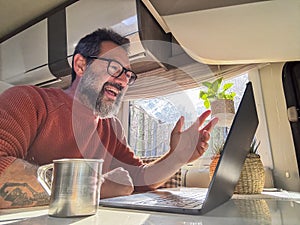 One digital nomad working inside a camper van travel lifestyle vehicle vanlife using laptop computer and roaming internet