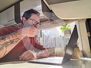 One digital nomad working inside a camper van travel lifestyle vehicle vanlife using laptop computer and roaming internet