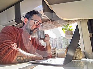 One digital nomad working inside a camper van travel lifestyle vehicle vanlife using laptop computer and roaming internet