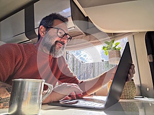 One digital nomad working inside a camper van travel lifestyle vehicle vanlife using laptop computer and roaming internet