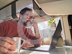 One digital nomad working inside a camper van travel lifestyle vehicle vanlife using laptop computer and roaming internet