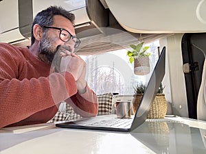 One digital nomad working inside a camper van travel lifestyle vehicle vanlife using laptop computer and roaming internet