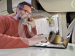 One digital nomad working inside a camper van travel lifestyle vehicle vanlife using laptop computer and roaming internet