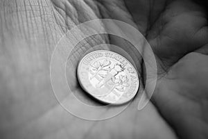 One dime coin on a palm of a hand