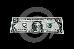 One dollar banknote isolated on black for business and finance