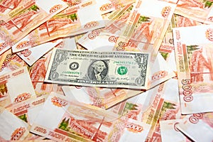 A one dollar banknote lies among a 5000 ruble banknote