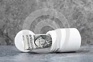 One dollar banknote rolled in the pills bottle