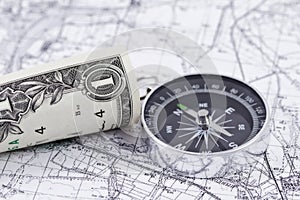 One-dollar bill, compass and map