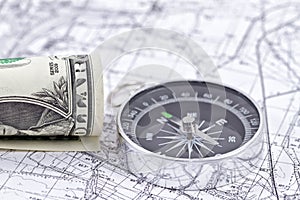 One-dollar bill, compass and map