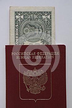 1 one dollar bill lie in red passport of Russian Federation. US dollar banknote inserted in Russian passport isolated on white photo