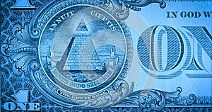 One dollar paper banknote in blue soft light. Macro shot of part of 1 dollar bill with pyramid and eye symbol, masonic