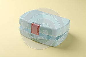 One empty lunch box on beige background