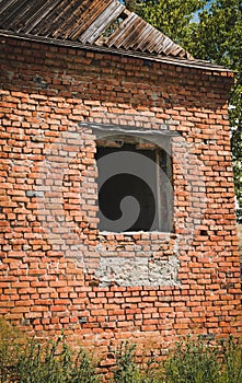 One empty window in an old red brick house