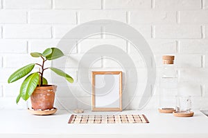 One empty wooden picture frame with white copy space on table wi