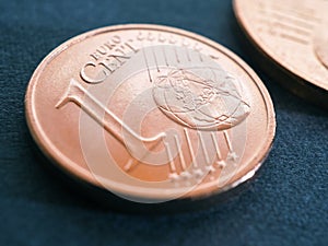A one euro cent coin lies on a dark blue-gray surface. Money close-up. Illustration on economic or financial theme. The withdrawal