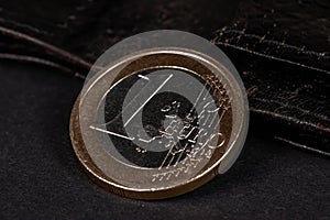 One Euro coin on black background close up