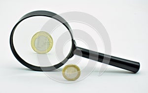 One euro coin observed with a magnifying glass photo