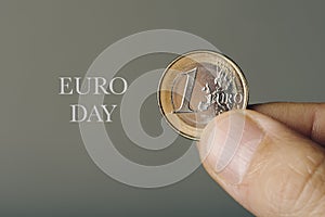 One euro coin and text euro day