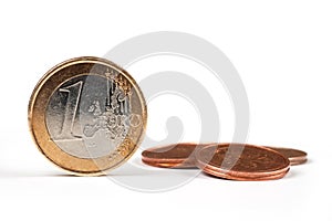 One Euro coin on white background, with many coins
