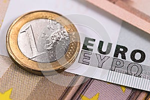 One euro metal coin and euros banknotes