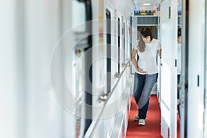 One european pregnant woman in t-shirt is getting belly pain while traveling by railway