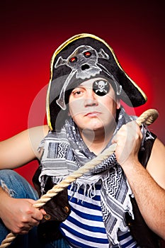 One-eyed pirate with a cocked hat and a rope