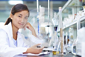 Asian Laboratory scientist working at lab with test tubes