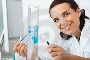 one female laboratory scientist working at lab with test tubes