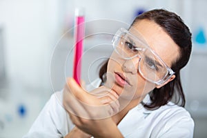 one femalelaboratory scientist working at lab with test tubes