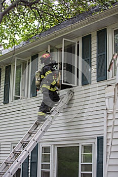 One Firefighter on Fire Scene in front of a building