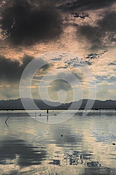 One fisherman silhouette view on bamboo raft