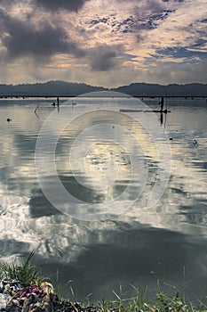 One fisherman silhouette view on bamboo raft