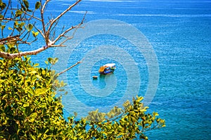 One the fishing boat and around bamboo boat on the sea.