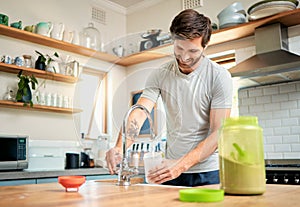 One fit young caucasian man pouring water into a bottle for chocolate whey protein shake for energy for training workout