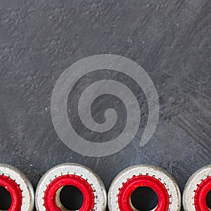 One Flat pop rivet with stainless steel mandrel on black tectured chalk board surface. Close up. Black and white