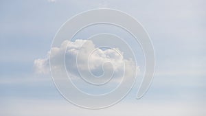 One fluffy cloud on a light blue sky panorama background