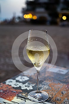 One flute glass of cold sparkling wine champagne brut