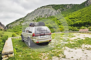 One four wheel drive white grey car parked roadside back view surrounded by green springtime nature. Visit eagle valley in
