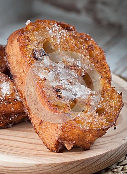 One french toast on a wooden plate