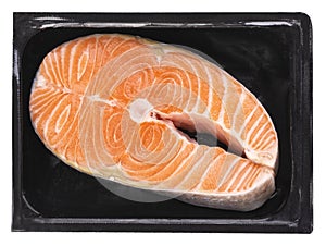 One fresh raw Norwegian salmon steak in a black plastic box